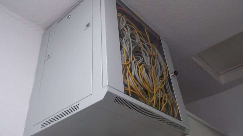 A tangled ethernet cable cupboard at Goldsmiths